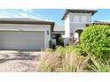 Two-car garage and landscaped front yard at 12505 Marsh Pointe Rd, Sarasota, FL 34238