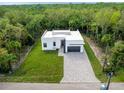 Aerial view of a modern house with a large yard at 14135 Carrie Ave, Port Charlotte, FL 33953