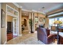Elegant living room with fireplace, hardwood floors, and access to backyard at 2029 Calusa Lakes Blvd, Nokomis, FL 34275