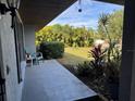 Inviting front porch with a chair and side table, overlooking a lush green lawn at 2204 51St E Blvd, Bradenton, FL 34208