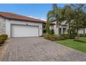 Front view of house with two-car garage and paver driveway at 2532 Avolet Ct, Lakewood Ranch, FL 34211