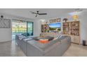 Open living space with gray sectional sofa and pool view at 3719 Scrub Creek Run, Bradenton, FL 34211