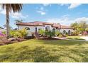 Single-Gathering home with red tile roof, landscaping, and large yard at 5156 Little Brook Ct, Sarasota, FL 34238