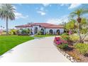 Luxury home with palm trees, manicured lawn, and circular driveway at 5156 Little Brook Ct, Sarasota, FL 34238