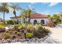 One-story house with red tile roof, lush landscaping, and stone accents at 5156 Little Brook Ct, Sarasota, FL 34238