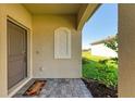 Front porch with a door, welcome mat, and decorative wall at 5514 Tidal Breeze Cv, Bradenton, FL 34211