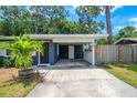 Navy blue house exterior with carport and tropical landscaping at 560 Bradenton Rd, Venice, FL 34293