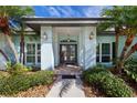 Inviting front entrance with double doors and decorative lighting at 7917 Broadmoor Pines Blvd, Sarasota, FL 34243