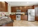 Spacious kitchen with stainless steel appliances and dark wood cabinets at 8277 Villa Grande Ct, Sarasota, FL 34243