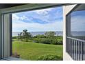 Water view from the porch with green grass and palm trees at 1010 Tidewater Shores Loop # 201, Bradenton, FL 34208