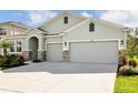 New construction home with two-car garage and landscaping at 16926 Harvest Moon Way, Bradenton, FL 34211