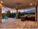 Spacious outdoor kitchen and patio area perfect for entertaining guests poolside at 5058 Surfside Cir, Lakewood Ranch, FL 34211