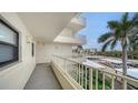 Spacious balcony overlooking parking lot and partial ocean view at 5760 Midnight Pass Rd # 307D, Sarasota, FL 34242