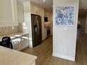 Bright eat-in kitchen with stainless steel appliances, white cabinets, and decorative backsplash at 5760 Midnight Pass Rd # 307D, Sarasota, FL 34242