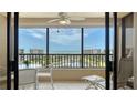 Enjoy the ocean views from this condo's lanai with seating and ceiling fan at 5770 Midnight Pass Rd # 705C, Sarasota, FL 34242