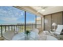 Enjoy the ocean views from this condo's screened lanai with seating and ceiling fan at 5770 Midnight Pass Rd # 705C, Sarasota, FL 34242