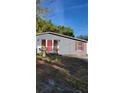 Gray house with red door and shutters, small front yard at 601 27Th W St, Bradenton, FL 34205