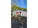 Gray house with red door and small front porch at 601 27Th W St, Bradenton, FL 34205