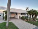 Charming waterfront cottage with a brick driveway at 957 Spanish N Dr, Longboat Key, FL 34228