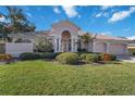 Single-story house with a three-car garage and well-maintained lawn at 1076 Mallard Marsh Dr, Osprey, FL 34229