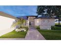 Front entrance and walkway leading to a single-story home with landscaping at 24480 Cabana Rd, Punta Gorda, FL 33955