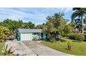 Aerial view showing a teal home with a gray roof and a spacious yard at 312 San Marie Dr, Punta Gorda, FL 33950