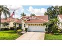 Charming single-story home featuring a red tile roof, well-maintained lawn, and attached two-car garage at 4872 Limetree Ln, Venice, FL 34293