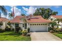 Cute and cozy one-story home with a red tile roof and nicely landscaped lawn at 4872 Limetree Ln, Venice, FL 34293