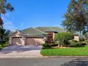 Beautiful home exterior with two car garage and manicured landscaping at 6828 Coyote Ridge Ct, University Park, FL 34201