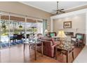 Spacious living room with hardwood floors, fireplace, and pool view at 6828 Coyote Ridge Ct, University Park, FL 34201
