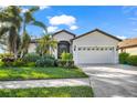 House exterior with a two-car garage and well-maintained landscaping at 8231 Stirling Falls Cir, Sarasota, FL 34243