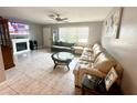 Spacious living area featuring a large sectional sofa, tile floors, and a fireplace at 108 Shell Rd, Venice, FL 34293