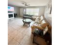 Bright living room with a comfortable sectional sofa and a large flat-screen TV at 108 Shell Rd, Venice, FL 34293