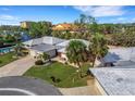 Bird's-eye view of waterfront property with private pool and lush landscaping at 115 Villa Dr # 115, Osprey, FL 34229