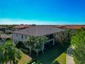 Rear view of two-story building with tile roof and screened balcony at 13711 Messina Loop # 102, Bradenton, FL 34211