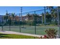 Community tennis court with green surface and fence at 1801 Gulf N Dr # 222, Bradenton Beach, FL 34217