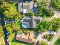 Bird's-eye view showcasing a house with a pool and a private dock, nestled amongst the greenery at 1899 Buccaneer Cir, Sarasota, FL 34231