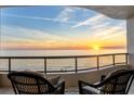 Breathtaking sunset view from a condo balcony, featuring comfortable seating at 415 L Ambiance Dr # C403, Longboat Key, FL 34228