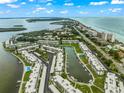Wide aerial showcasing the community's waterfront location and landscaping at 4360 Chatham Dr # 108, Longboat Key, FL 34228