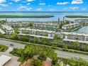 Aerial view of waterfront community with lush landscaping and boat access at 4360 Chatham Dr # 108, Longboat Key, FL 34228