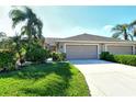 Two-story home with double garage and manicured lawn at 5156 Mahogany Run Ave, Sarasota, FL 34241