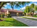 Two-car garage with a well-maintained front yard and driveway at 6241 Timberlake Dr # D7, Sarasota, FL 34243