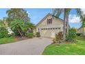 House exterior featuring a paved driveway and lush landscaping at 7615 Windward Cv, Lakewood Ranch, FL 34202