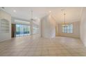 Bright and airy living room with tile flooring and sliding doors at 7615 Windward Cv, Lakewood Ranch, FL 34202