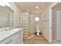 Clean bathroom with a glass block shower, white vanity, and marble countertop at 3145 Kingston St, Port Charlotte, FL 33952