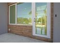 Townhouse entry with glass door, wood-like tile, and modern fixtures at 1720 Alderman St, Sarasota, FL 34236