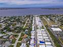 Community aerial view with waterfront access, retail shopping and tranquil tree lined streets at 2107 Palma Sola Blvd # 84, Bradenton, FL 34209