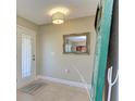 Bright and airy foyer with a mirror and a welcome mat at 220 Monet Dr, Nokomis, FL 34275