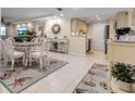 Charming dining area with glass-top table, white chairs, and a coastal-themed rug at 4119 61St Avenue W Ter # 105, Bradenton, FL 34210