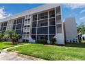 Modern condo building featuring floor-to-ceiling screened windows and well maintained landscaping and green space at 4119 61St Avenue W Ter # 105, Bradenton, FL 34210